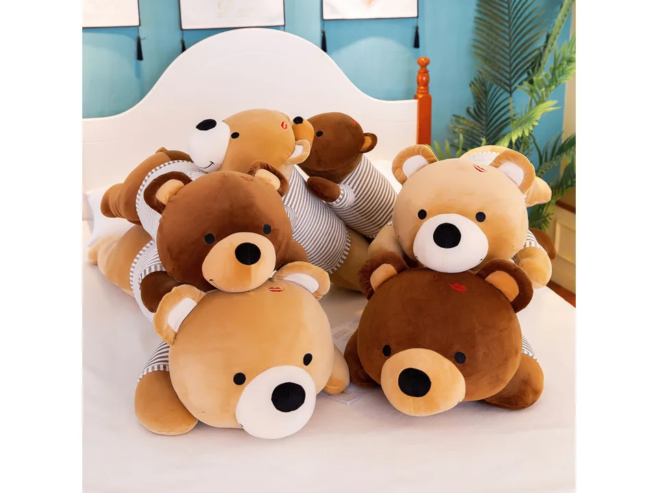 A group of four plush bear toys in different colors and sizes.