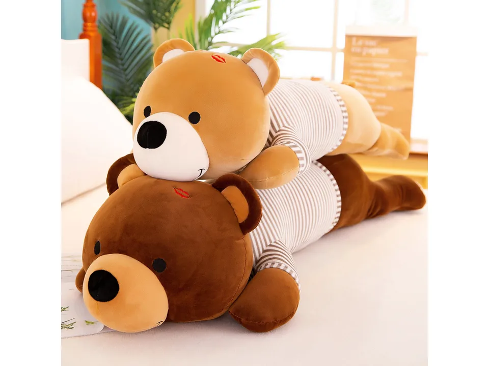 Two plush bear toys, one light brown and one dark brown, stacked on a bed.