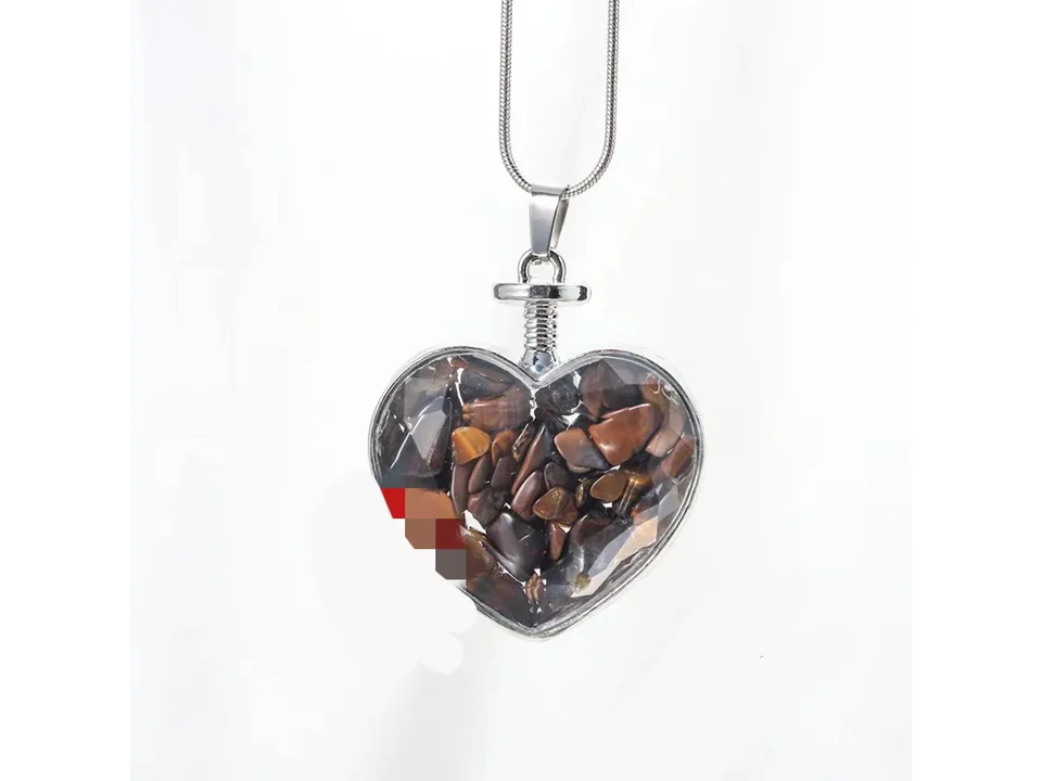 Heart-shaped pendant necklace filled with brown crystal gravel on a silver chain.