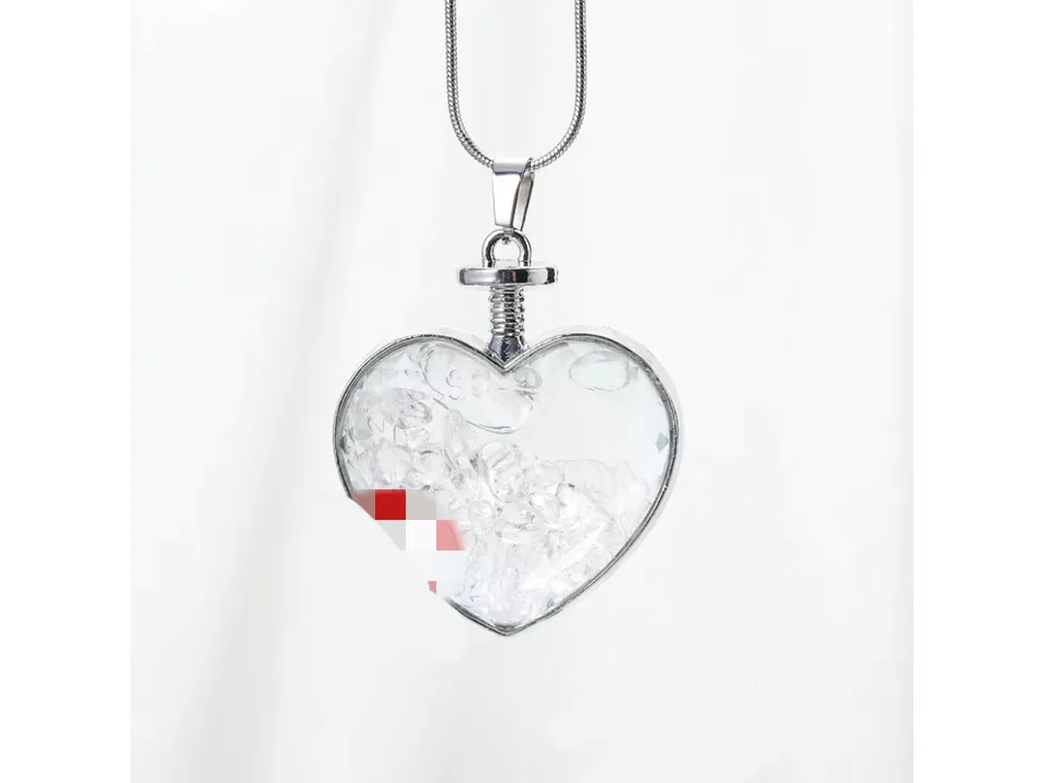 Heart-shaped pendant necklace filled with clear crystal gravel on a silver chain.