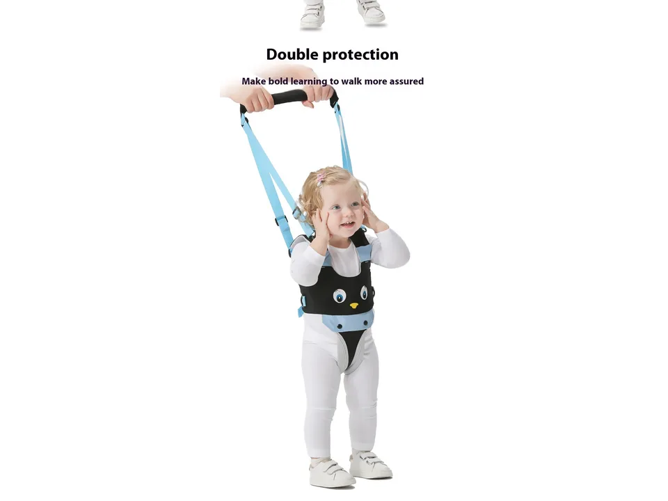 A toddler standing while wearing a blue and black baby walking harness.
