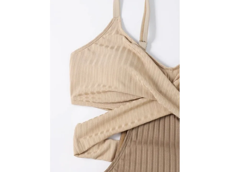 Close-up of the ribbed fabric and crisscross strap detail on the swimsuit.