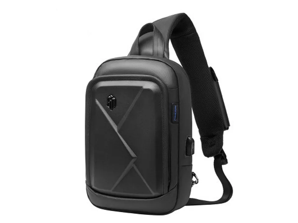 A side-angle view of the black chest bag showing the strap and side details.