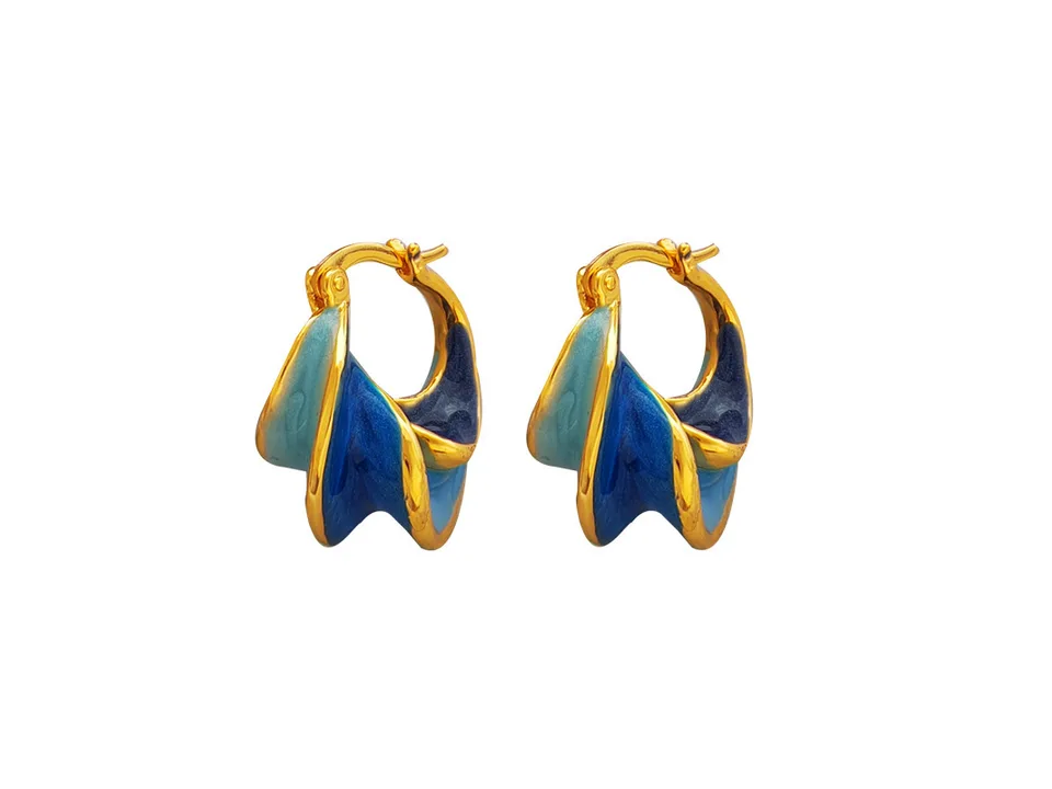 A pair of blue and gold spiral hoop earrings on a white background.