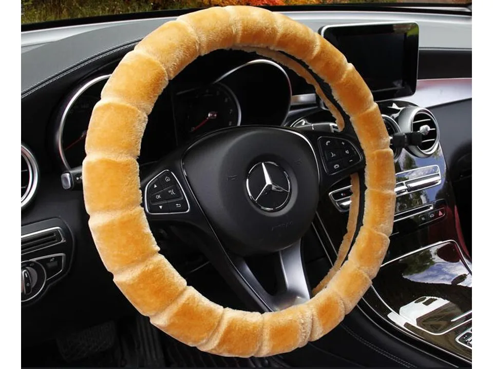 An orange plush steering wheel cover installed on a Mercedes steering wheel.