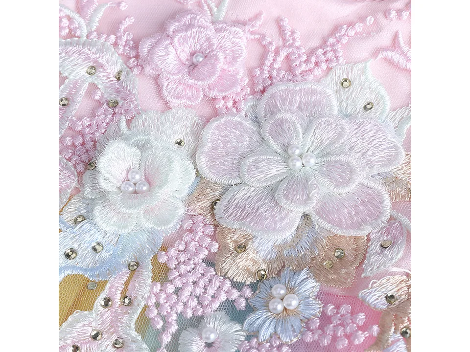 Close-up of the intricate floral lace and pearl bead details on the dress.