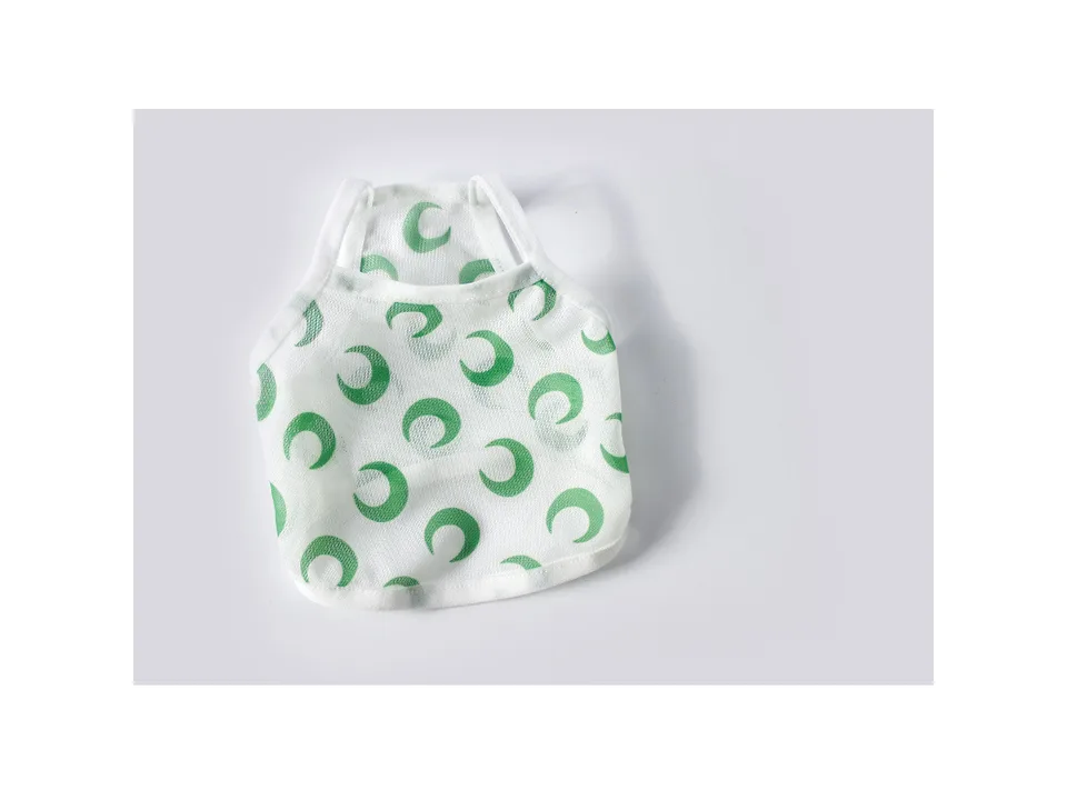 A moon print mesh pet vest with green trim.