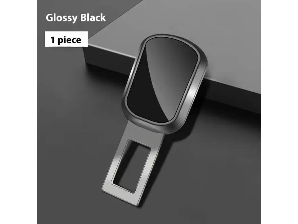 A glossy black car seat belt buckle extender plug.