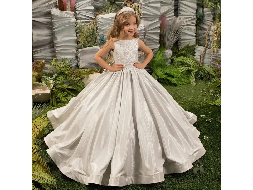 Front view of a girl wearing a silver formal dress with a full skirt.