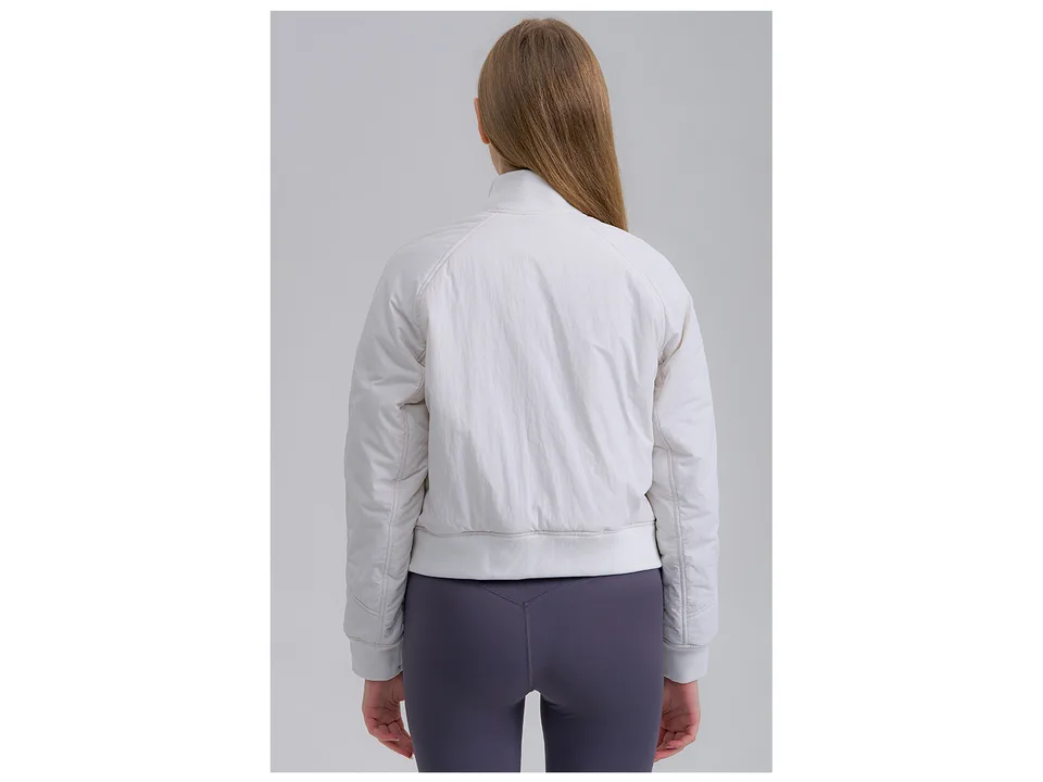Back view of a model wearing a white athletic jacket.
