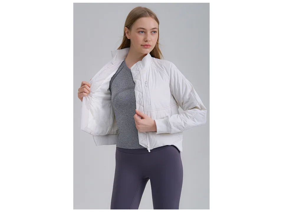 Model opening a white athletic jacket to show the interior lining.