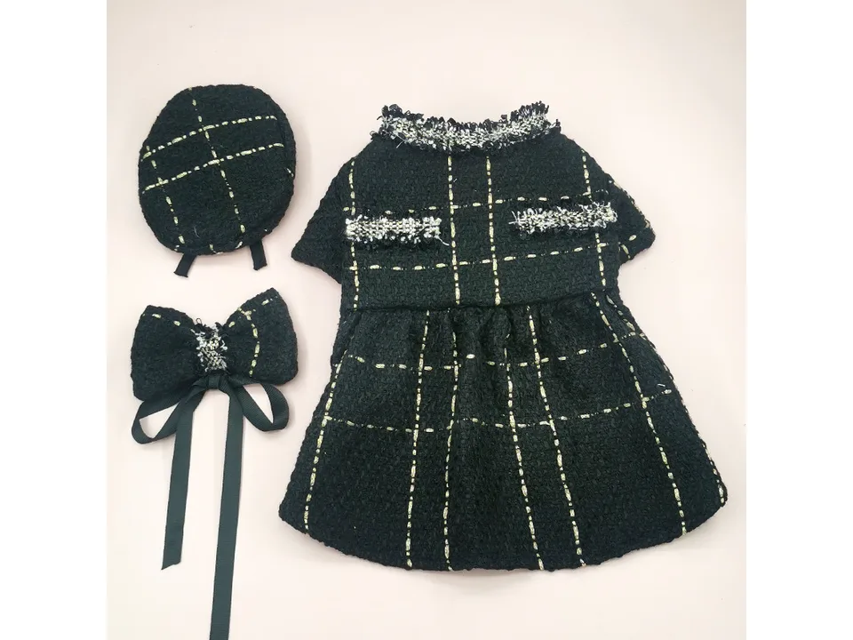 The black tweed coat, hat, and bow tie set laid out together.
