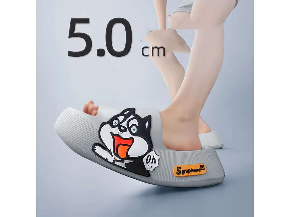 A person wearing a grey thick-soled sandal with a cartoon dog design.