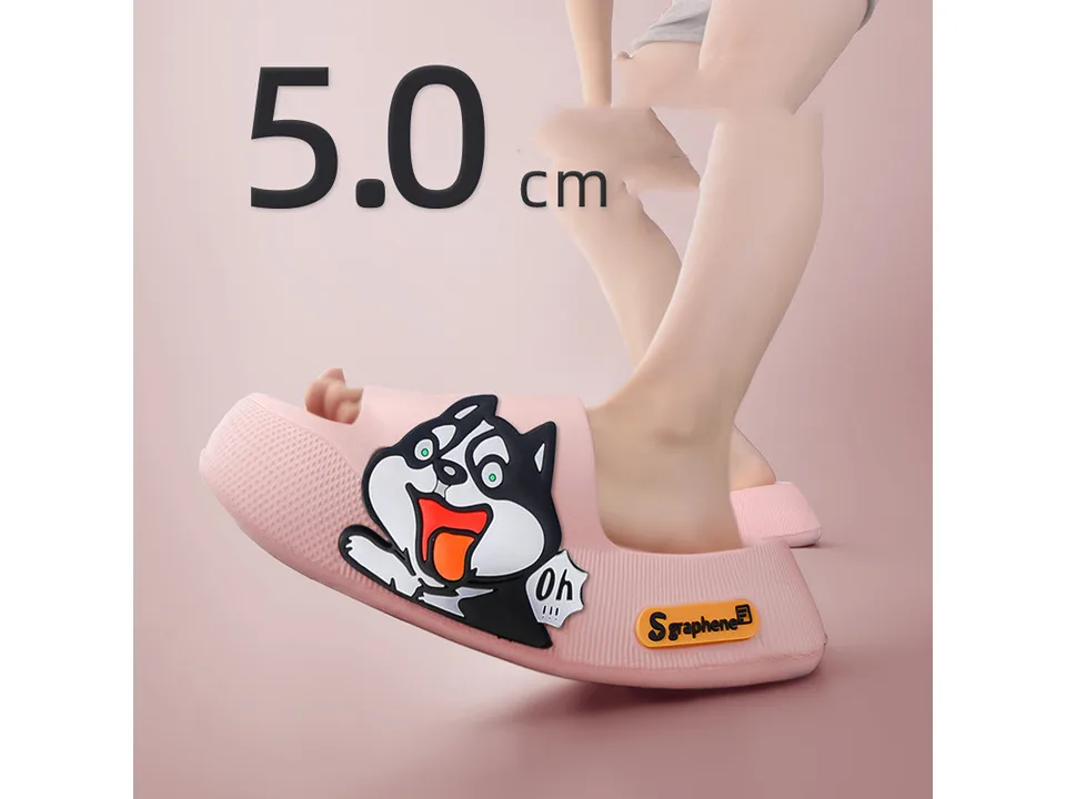 A person wearing a pink thick-soled sandal with a cartoon dog design.