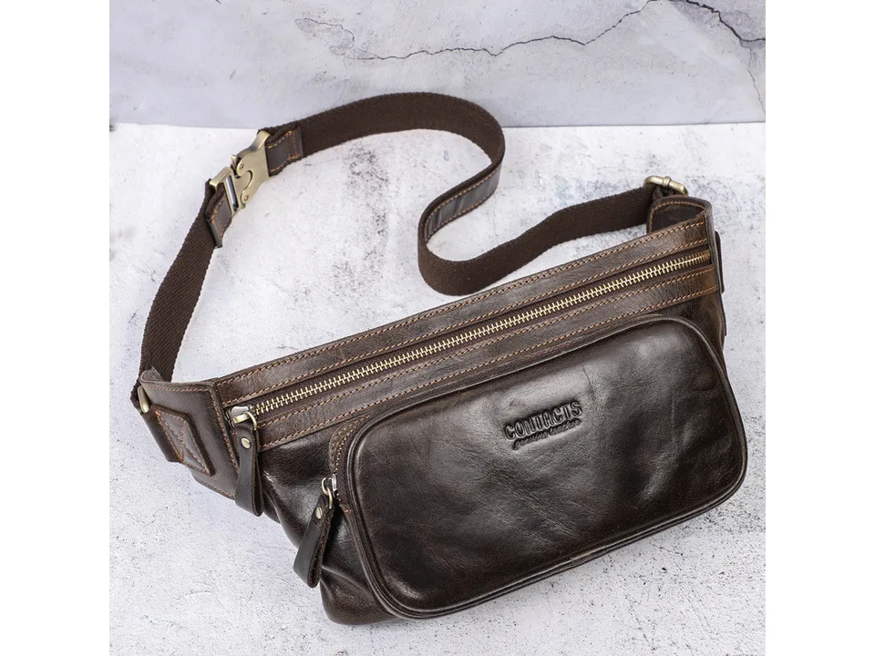 Brown leather waist bag on a textured background, showing the front pocket and strap.