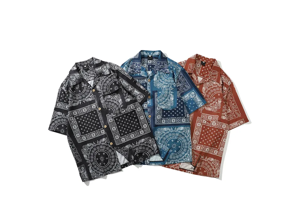 Three paisley print shirts in black, blue, and rust colors laid out together.