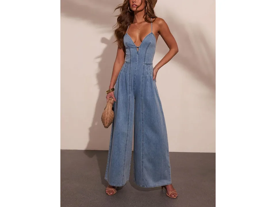 A woman wearing a sleeveless wide-leg denim jumpsuit.