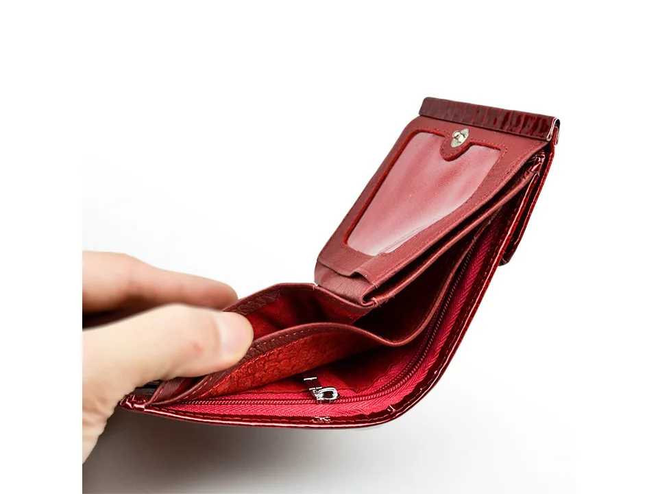 Open red leather wallet showing interior card slots and zipper pocket