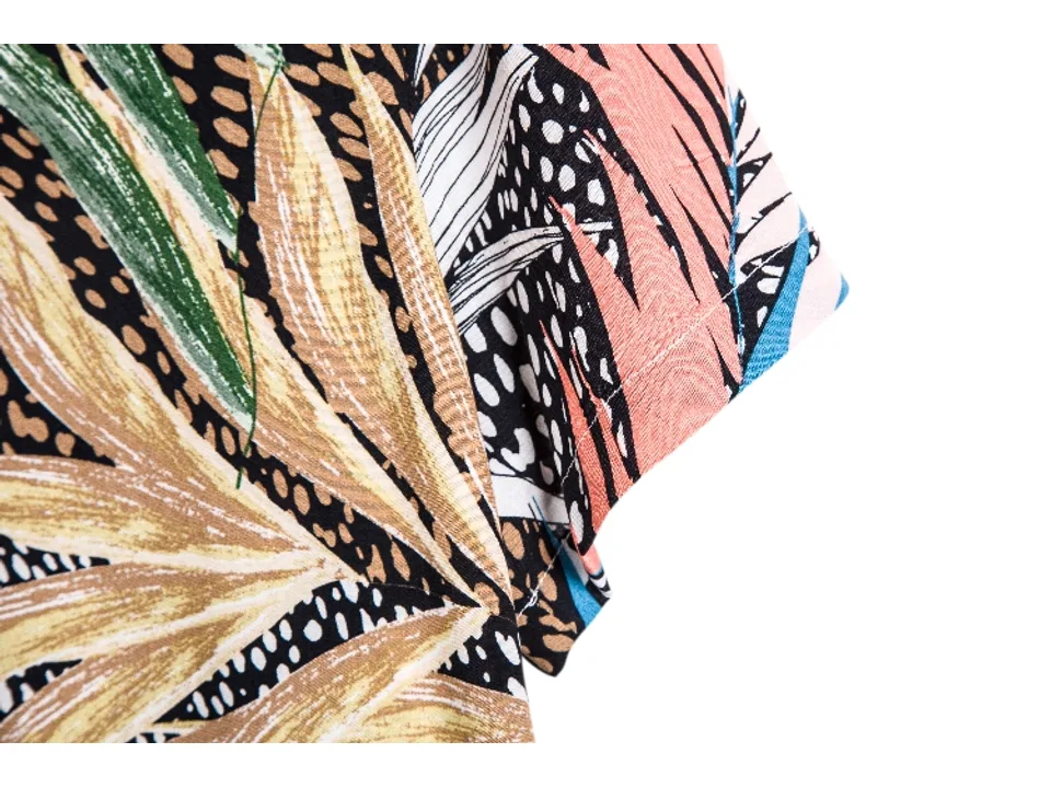 Close-up of the sleeve and fabric detail of the tropical print shirt.