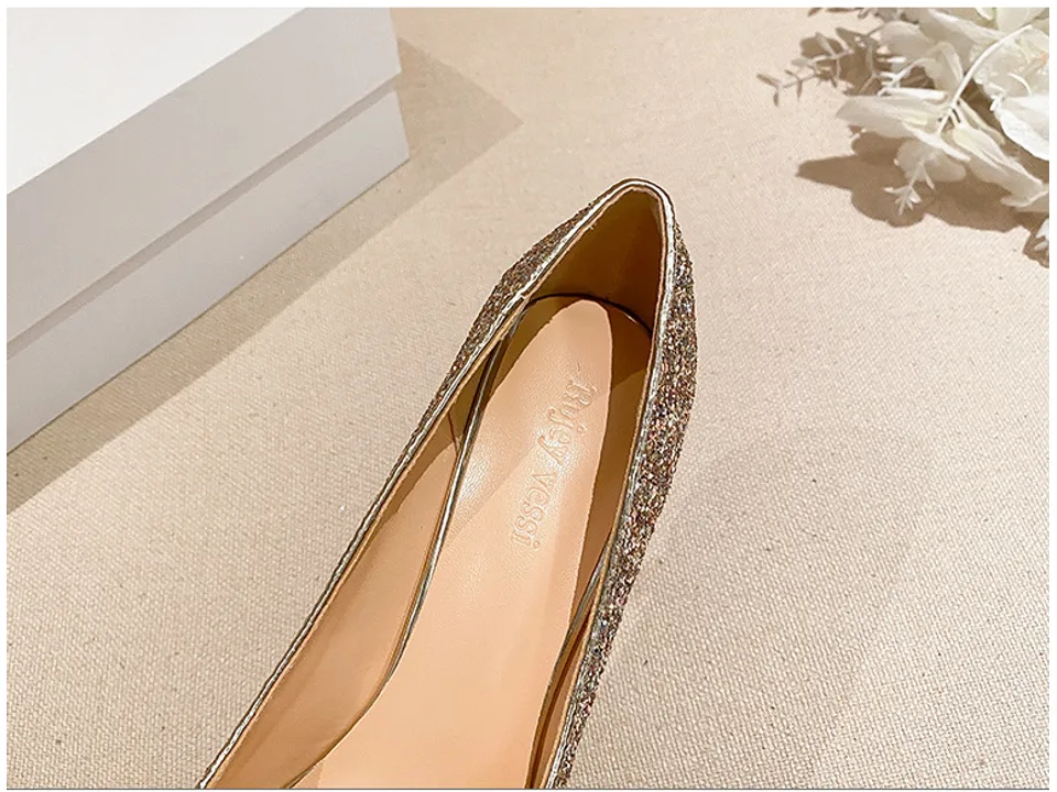 Close-up of the inside of a silver sequin pump showing the brand name.