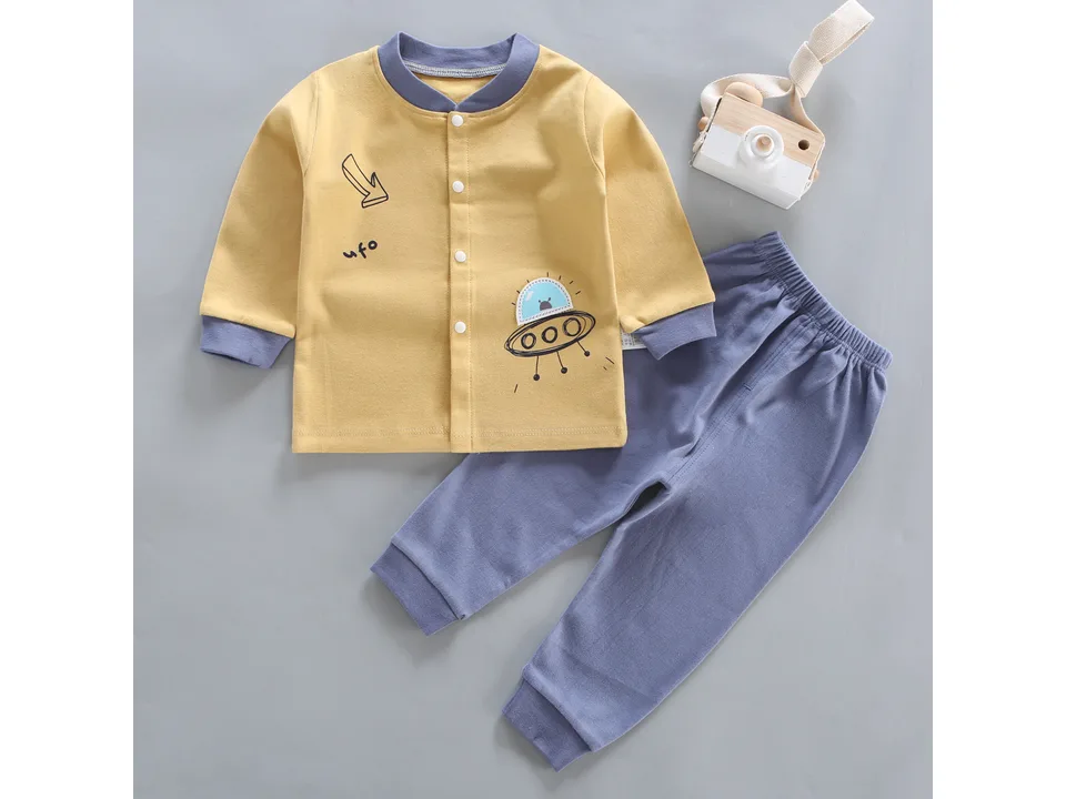 Yellow long-sleeve baby pajama top with a UFO graphic, paired with blue pants.