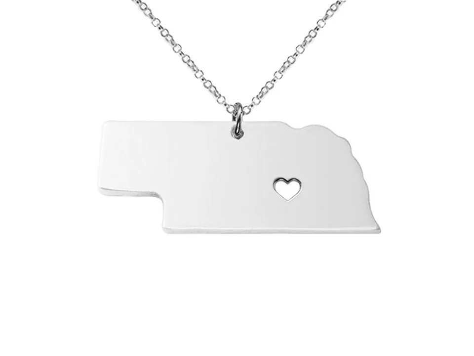 Silver-tone Nebraska state map pendant necklace with a heart cutout.