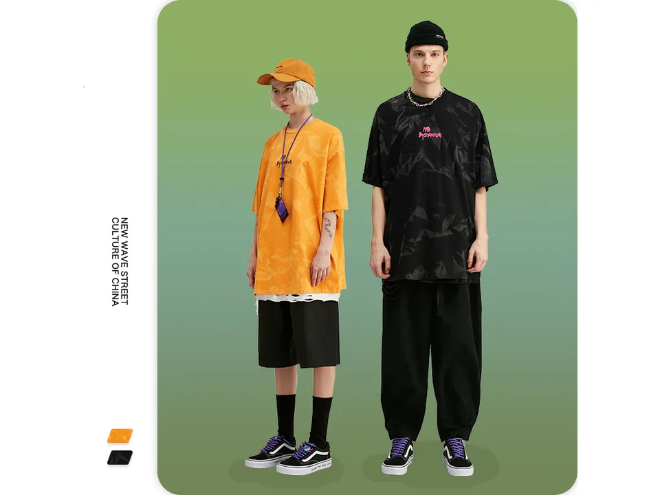 Male and female models wearing the oversized tie-dye t-shirts in orange and black.