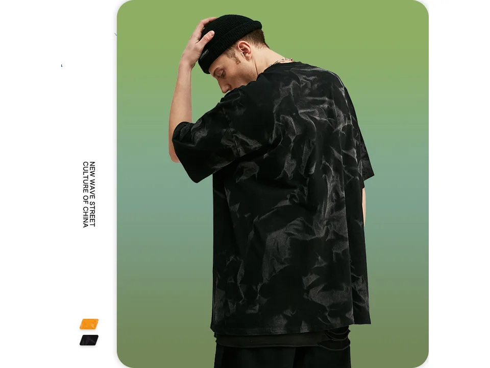 Male model seen from the back wearing the black oversized tie-dye t-shirt.