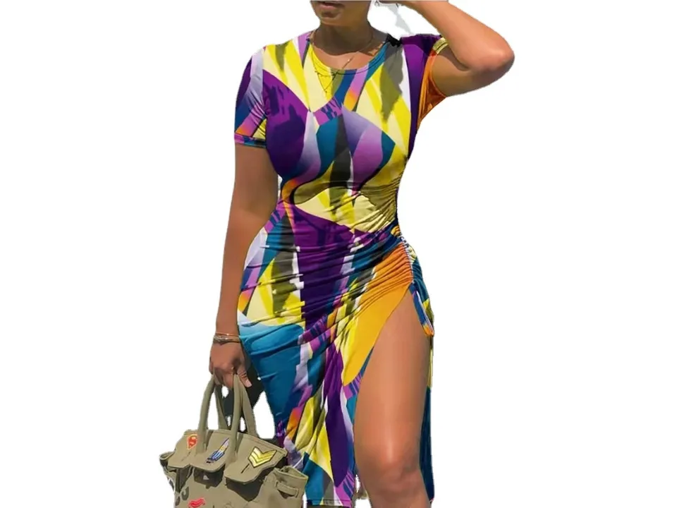 A woman wearing a colorful abstract print short sleeve midi dress with a high side slit.