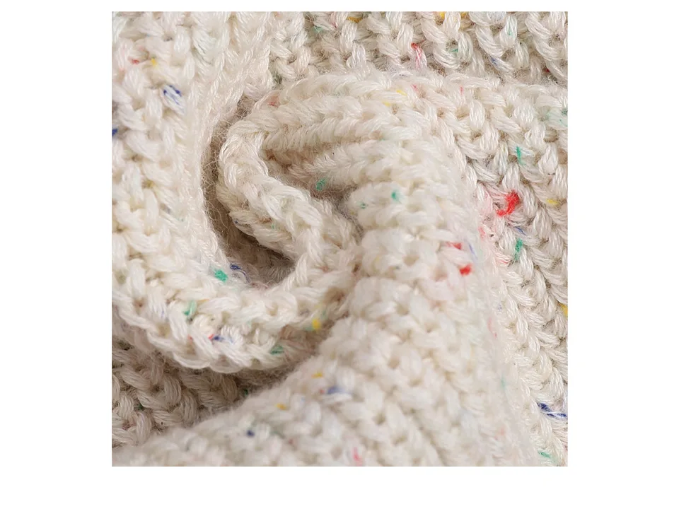 Detailed close-up of the soft, textured knit fabric of the sweater.