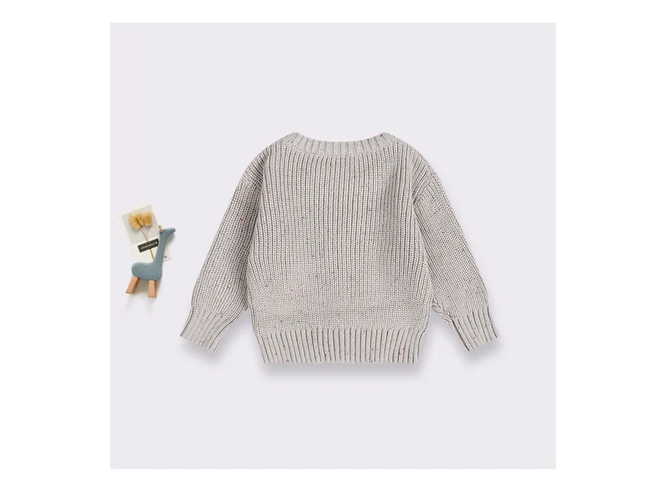 Full view of the beige knitted sweater with colorful flecks.