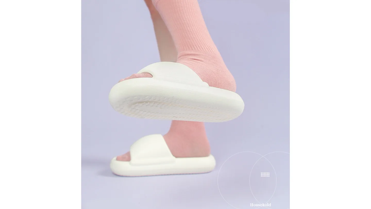 Close-up of the textured bottom of a white thick-soled slipper.