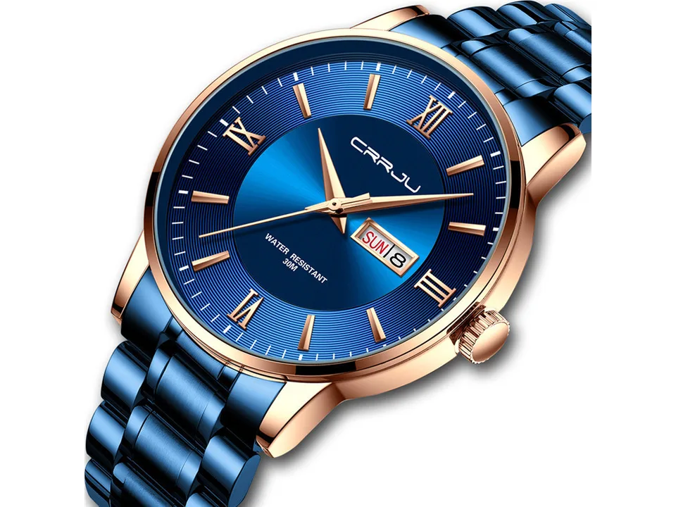 Close-up of a blue watch face with rose gold accents and date display.
