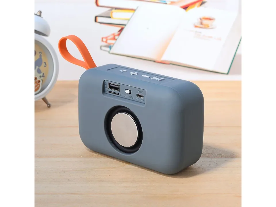 The back of a grey portable speaker showing USB, TF card, and AUX ports.