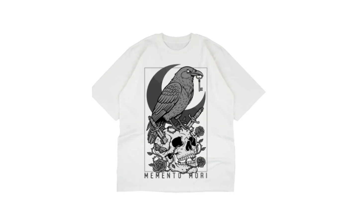 White t-shirt featuring a graphic print of a raven, skull, moon, and roses with the text Memento Mori.