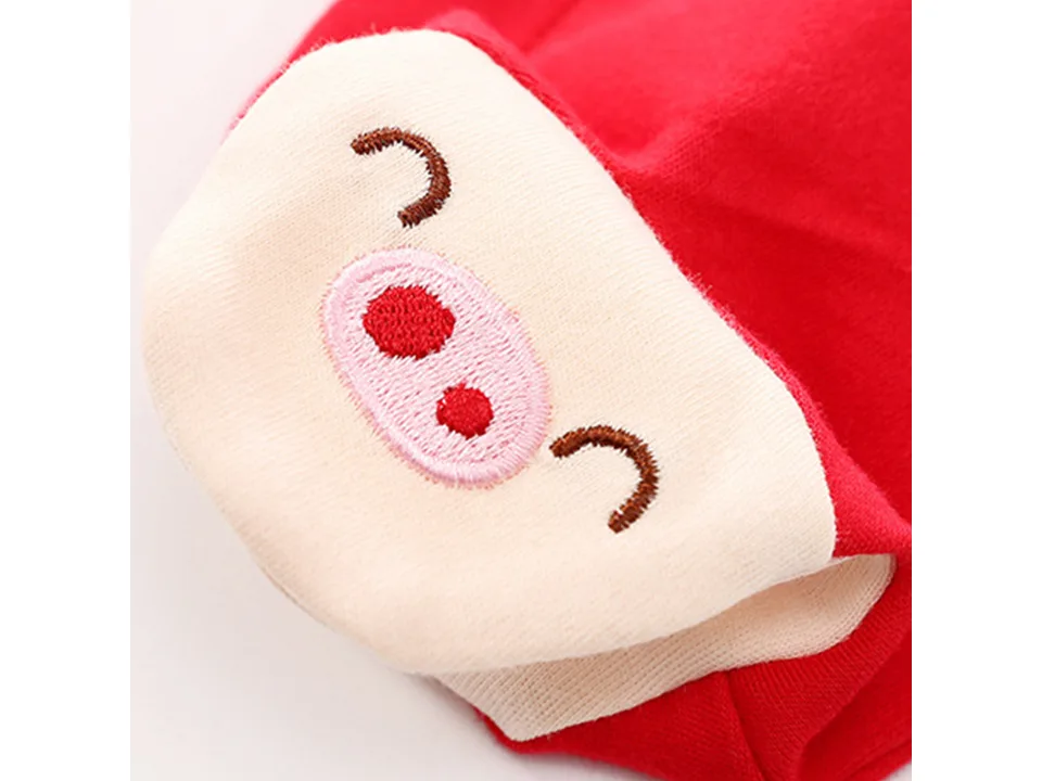 Close-up of a baby romper footie with an embroidered pig face.