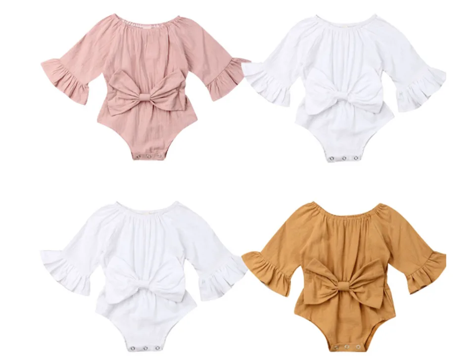 Four baby girl bodysuits with bow details in pink, white, and tan colors.
