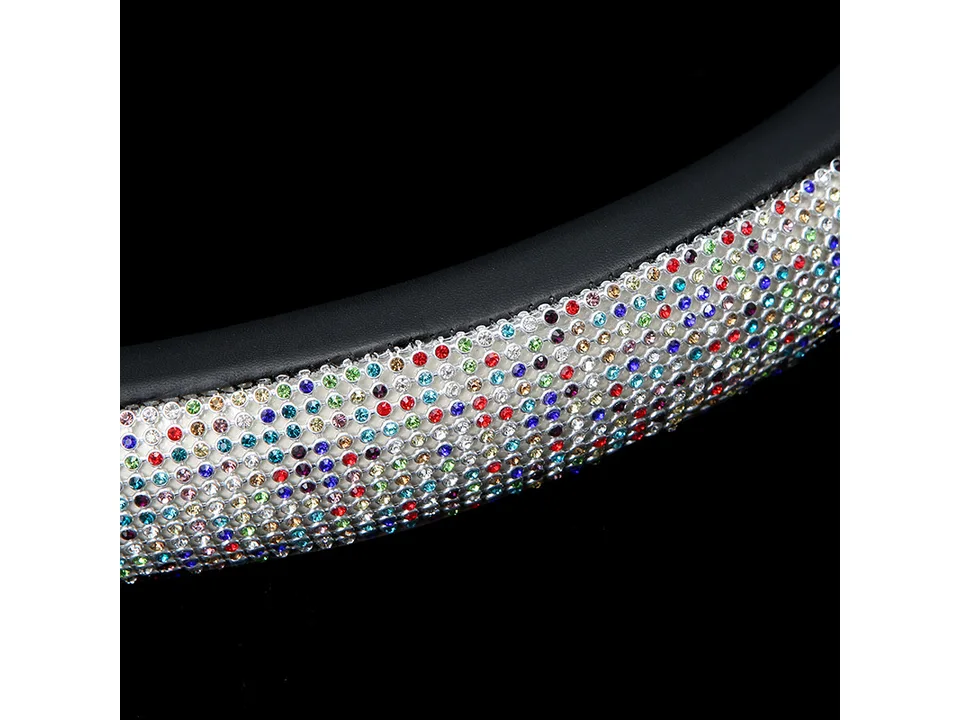Close-up view of a multi-colored rhinestone steering wheel cover.