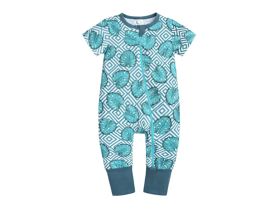 Full view of a teal baby jumpsuit with a tropical leaf and geometric pattern.