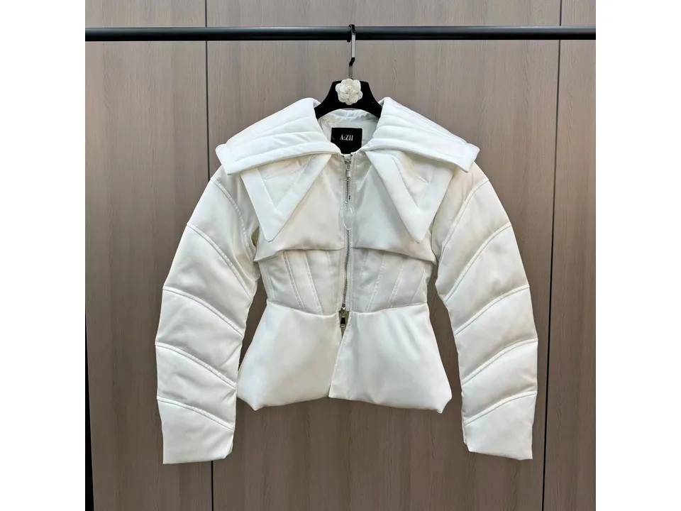 Full front view of the white jacket hanging on a rack, showing the zipper and wide collar.