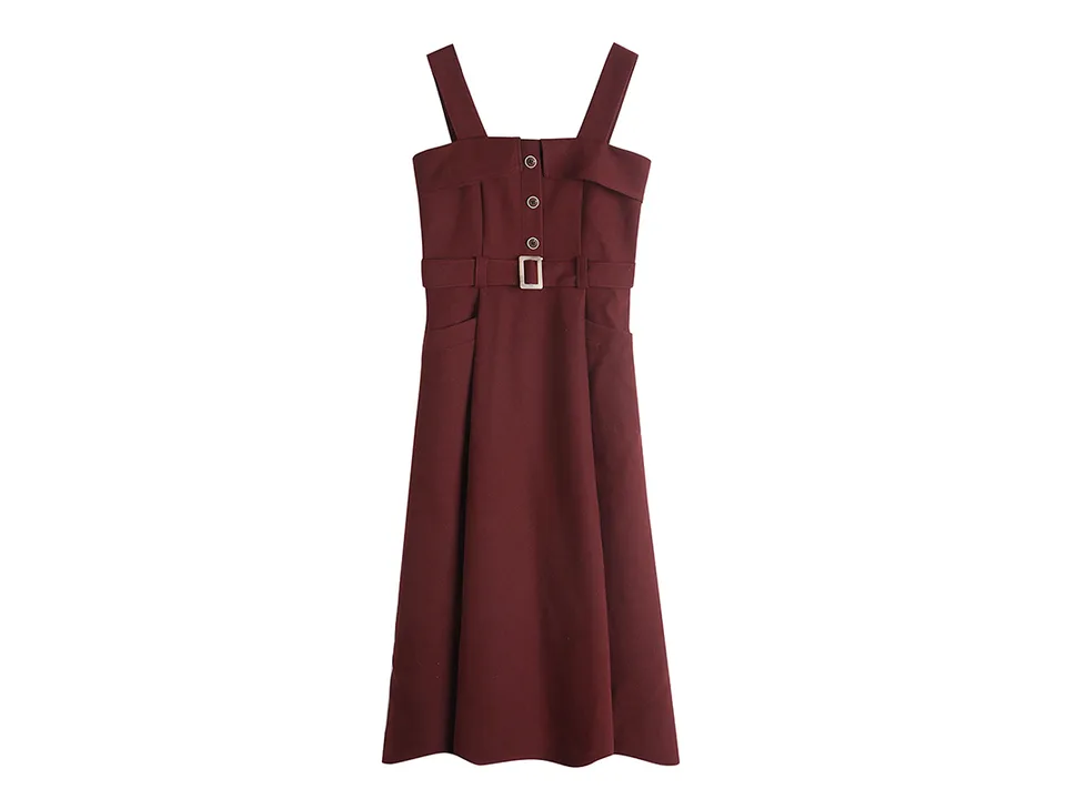 Burgundy corduroy pinafore midi dress with belt and button detail on a white background.