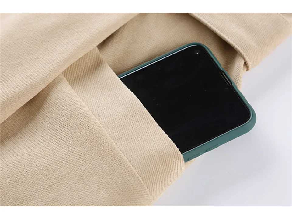 Close-up of the dress pocket with a smartphone inside.