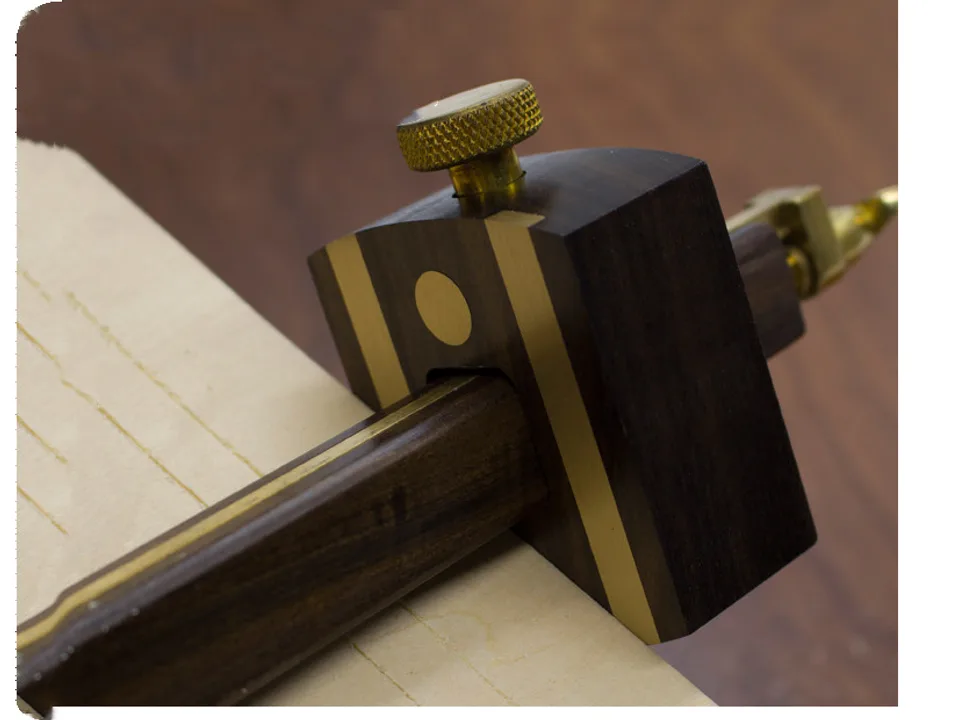 Woodworking marking gauge being used to scribe lines on wood