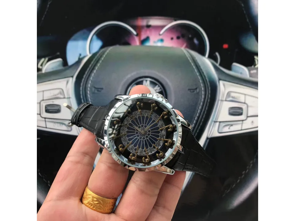 A close-up view of the men's watch held in a hand.