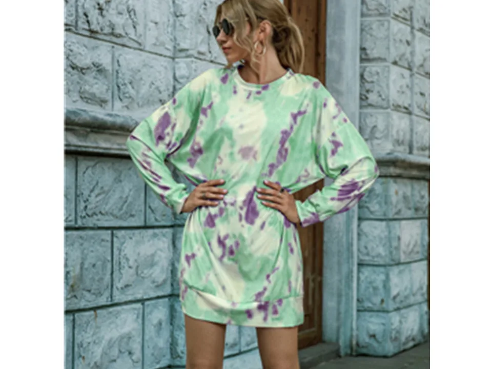 Model wearing a green and purple tie-dye long sleeve sweater dress.