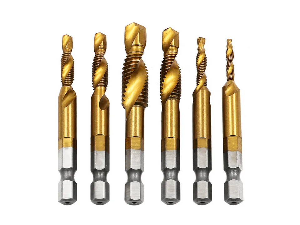 A set of six gold-colored metric hex shank drill and tap bits standing upright in a row.