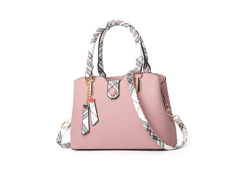 Pink casual shoulder handbag with plaid handle and strap accents.