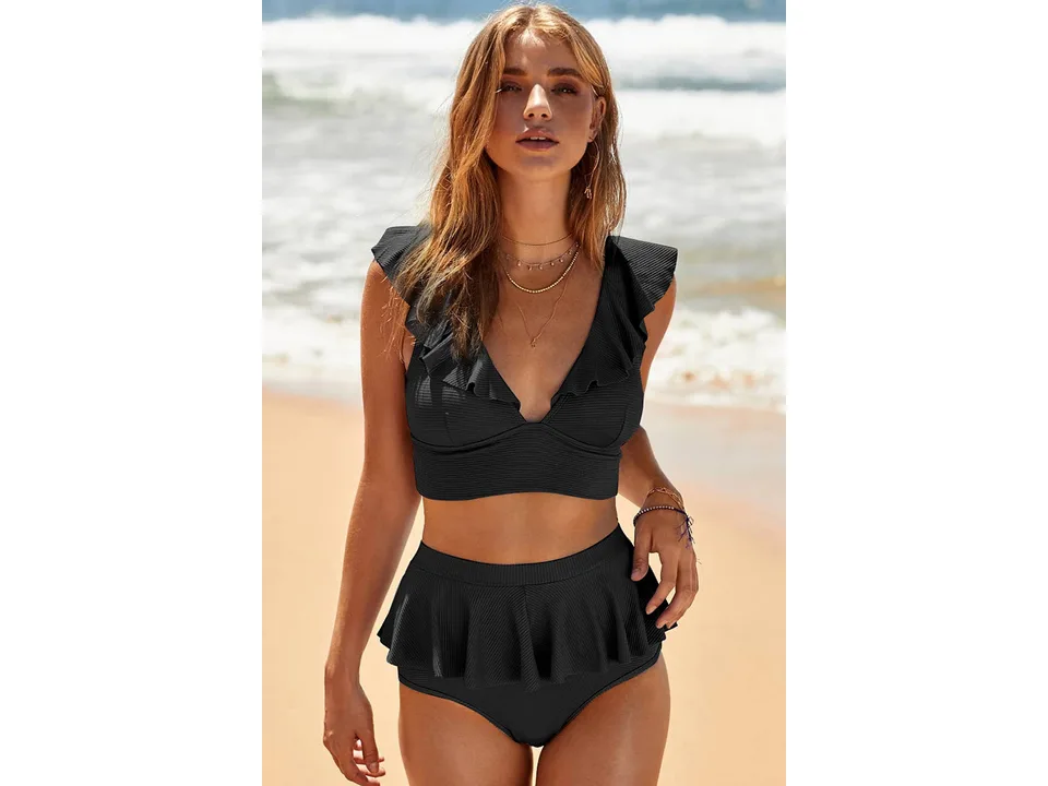 Front view of a woman wearing a black ruffled high-waisted bikini.