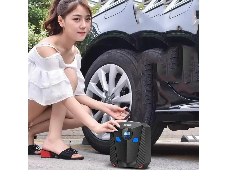 A woman using the portable tire inflator to inflate a car tire.