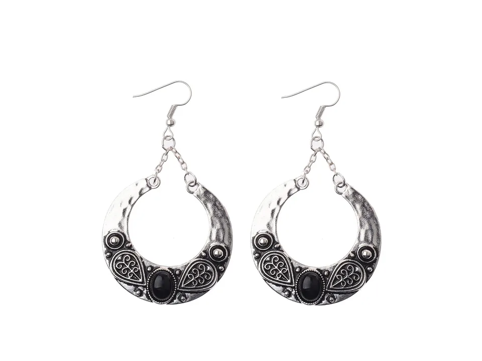 A pair of bohemian crescent-shaped earrings with black resin inlay.